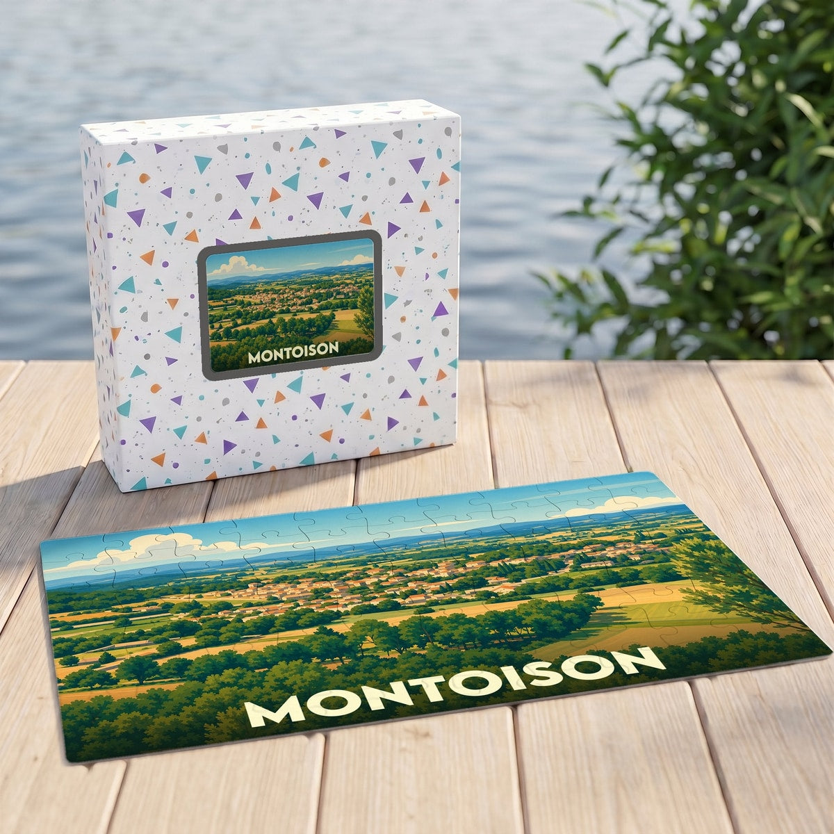 Puzzle souvenir de la ville de Montoison avec une illustration panoramique stylisée présentée à côté de sa boîte.
