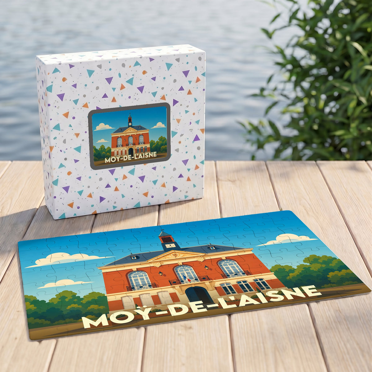Puzzle souvenir de la ville de Moÿ-de-l'Aisne avec son emballage, présentant une illustration stylisée de l'hôtel de ville.