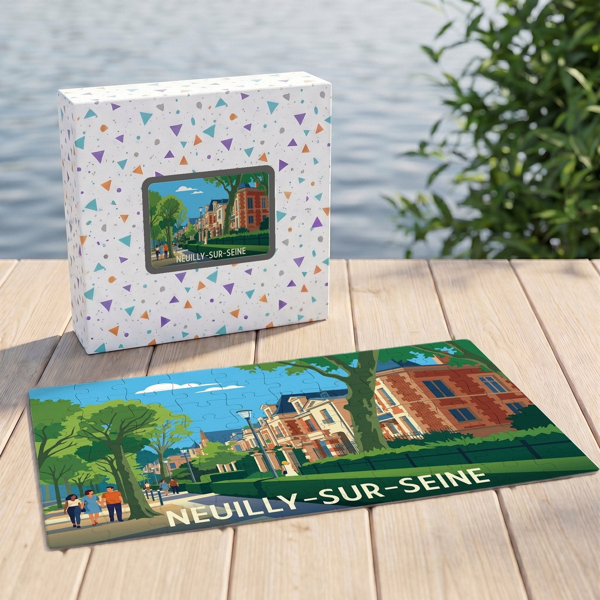 Puzzle souvenir de la ville de Neuilly-sur-Seine avec son coffret, illustré d'une scène urbaine colorée et stylisée.
