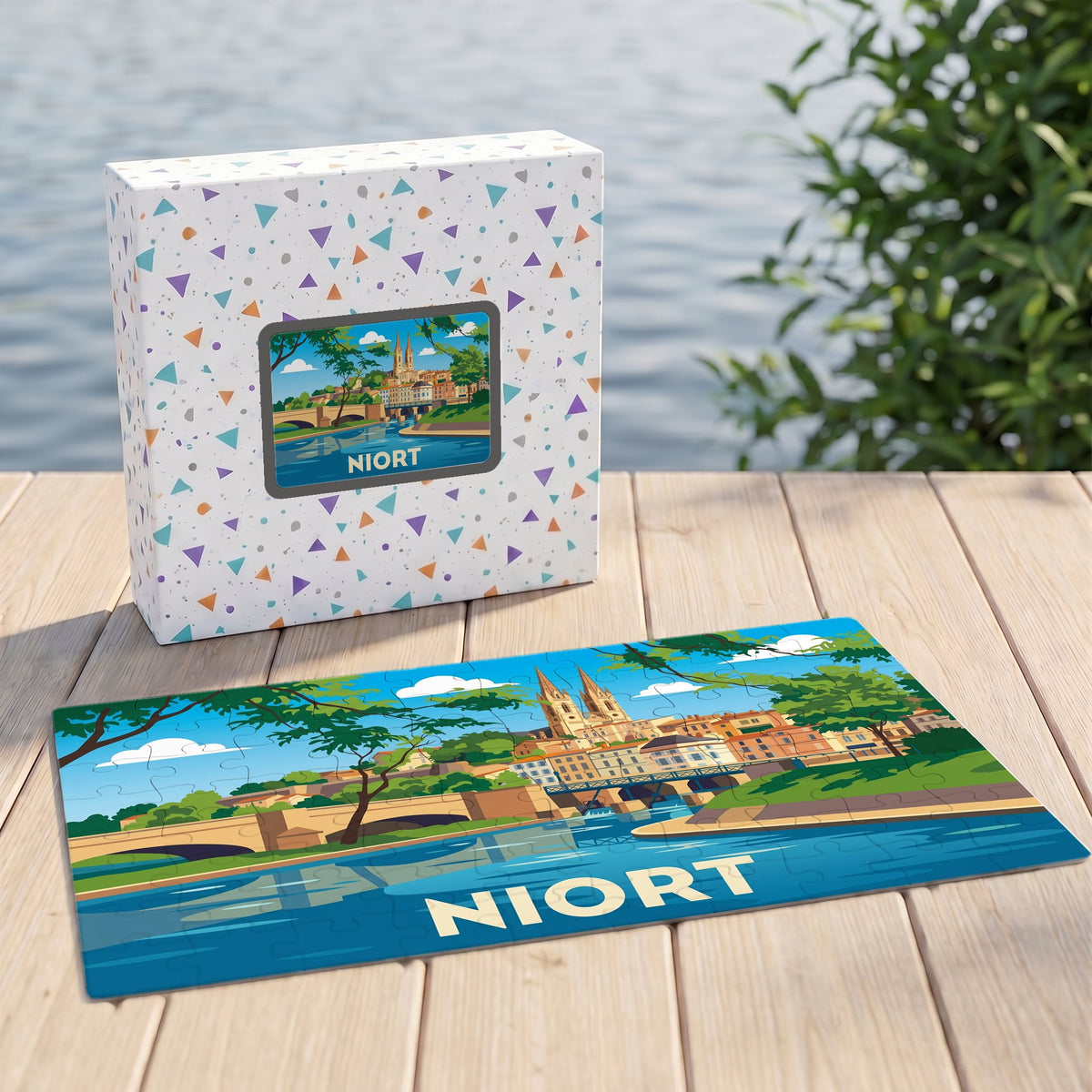 Puzzle souvenir de la ville de Niort avec une illustration stylisée du paysage urbain au bord de l'eau.