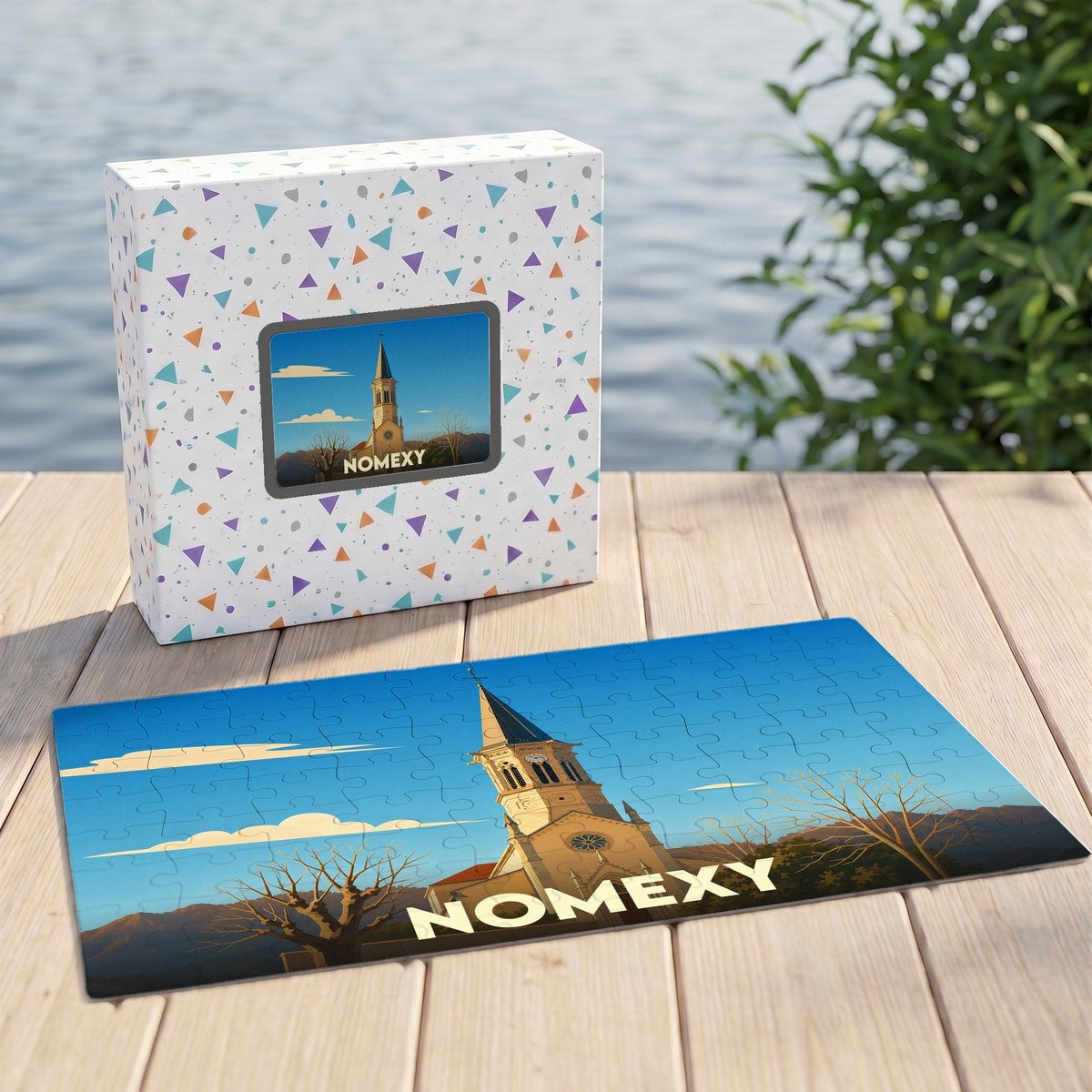 Puzzle souvenir de la ville de Nomexy avec une illustration stylisée d'un clocher.