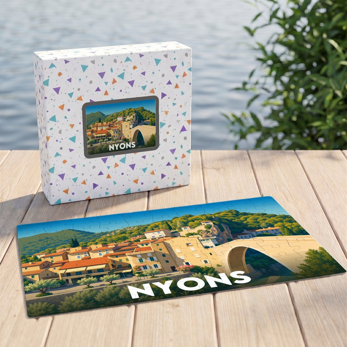 Puzzle souvenir de la ville de Nyons avec une illustration colorée de son pont emblématique et de ses maisons provençales.