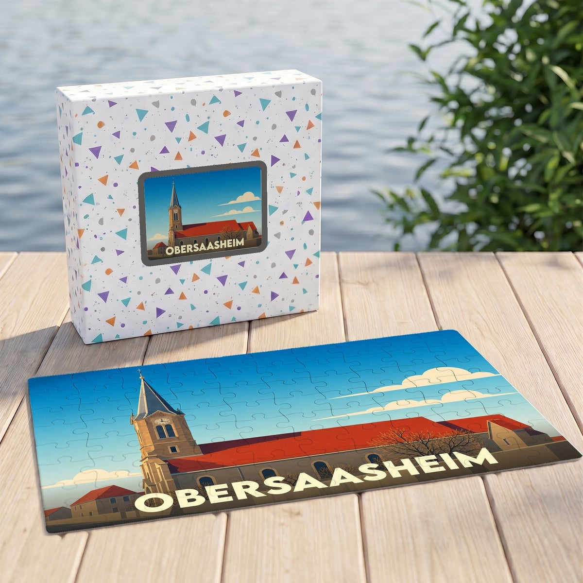 Puzzle souvenir de la ville d'Obersaasheim présentant une illustration stylisée d'une église sous un ciel bleu.