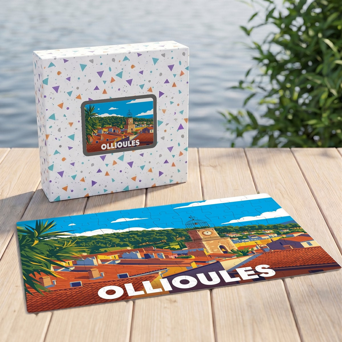 Puzzle souvenir de la ville d'Ollioules représentant une vue panoramique illustrée de ses toits et de son clocher.