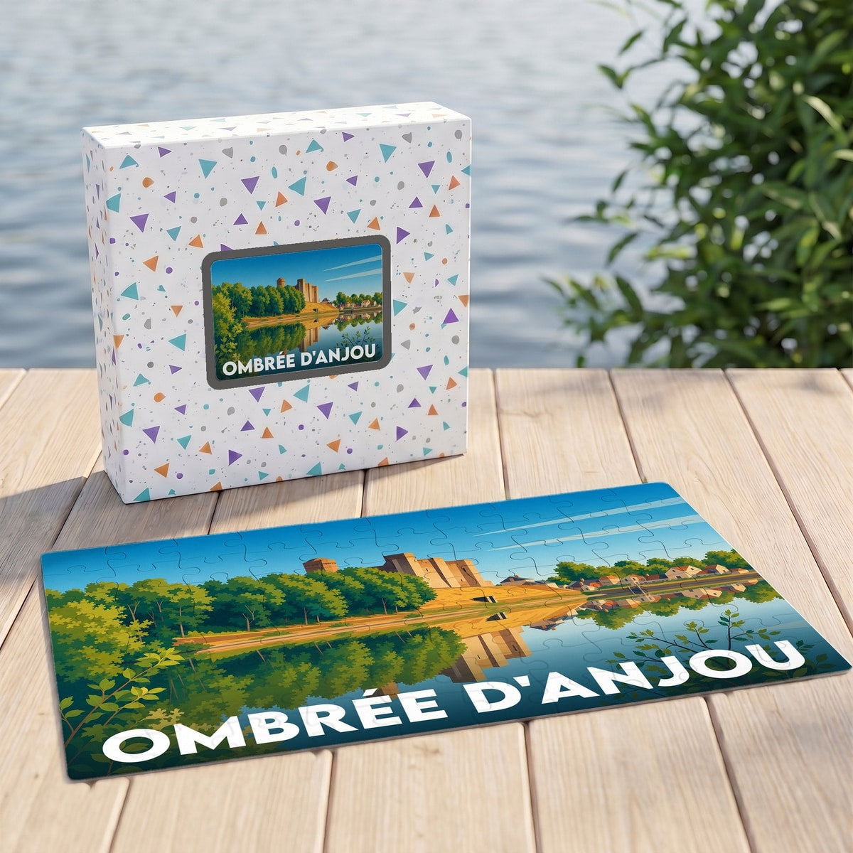 Puzzle souvenir de la ville de Ombrée d'Anjou avec une illustration stylisée d'un château se reflétant dans l'eau.