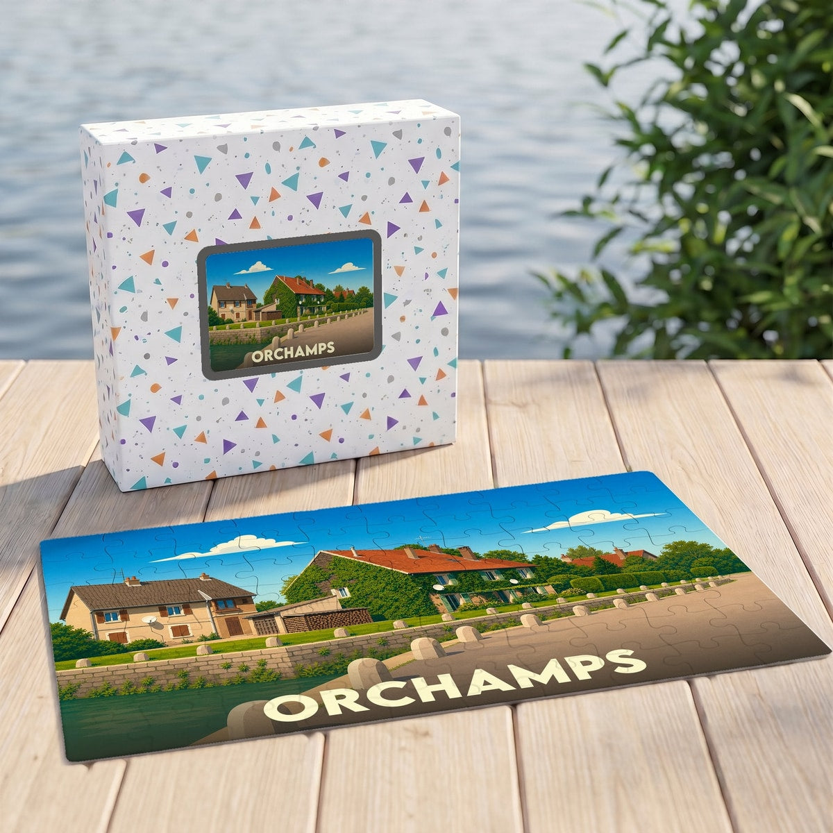 Puzzle souvenir de la ville d'Orchamps illustrant un paysage de maisons au bord de l'eau.
