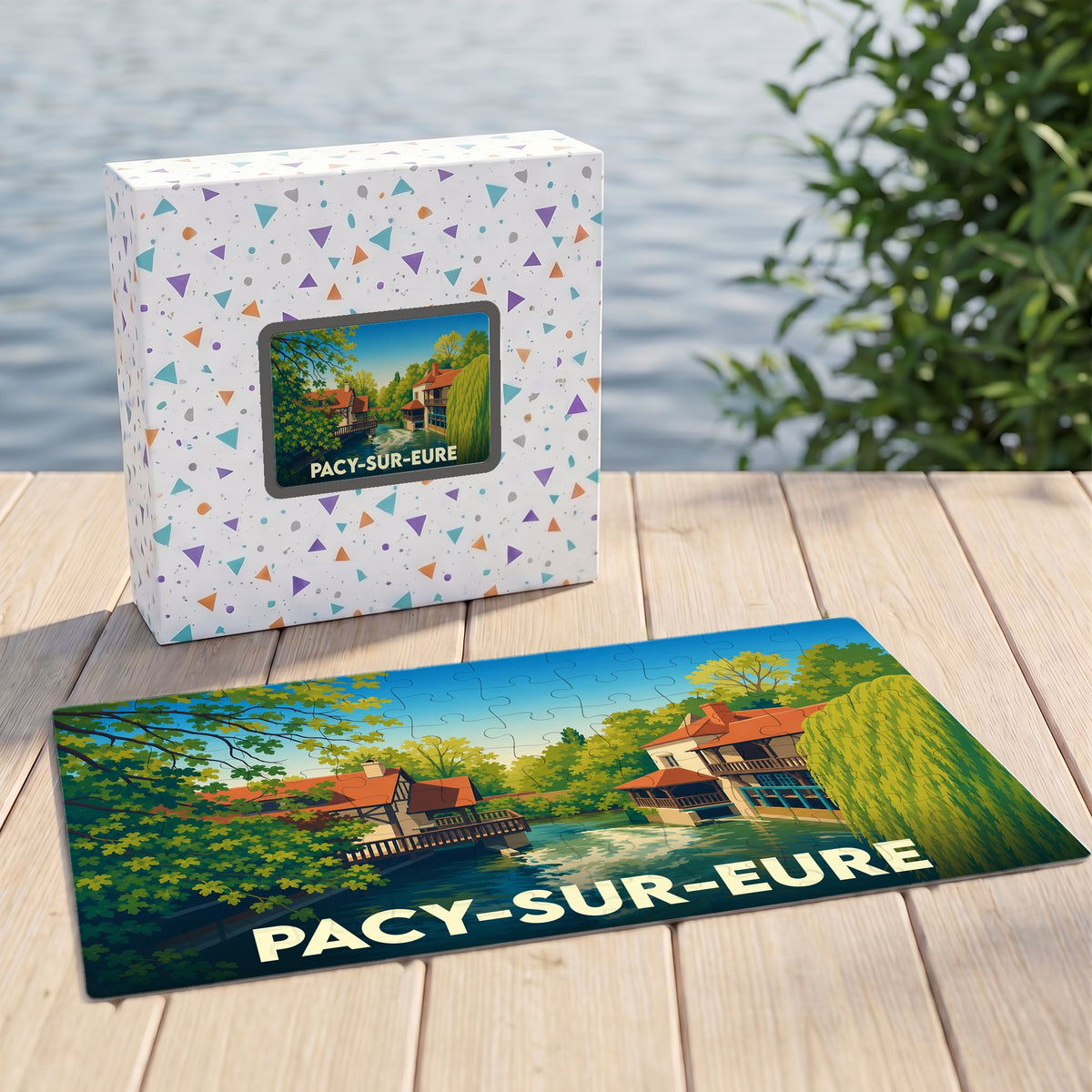 Puzzle souvenir de la ville de Pacy-sur-Eure avec une illustration stylisée de maisons au bord de l'eau.