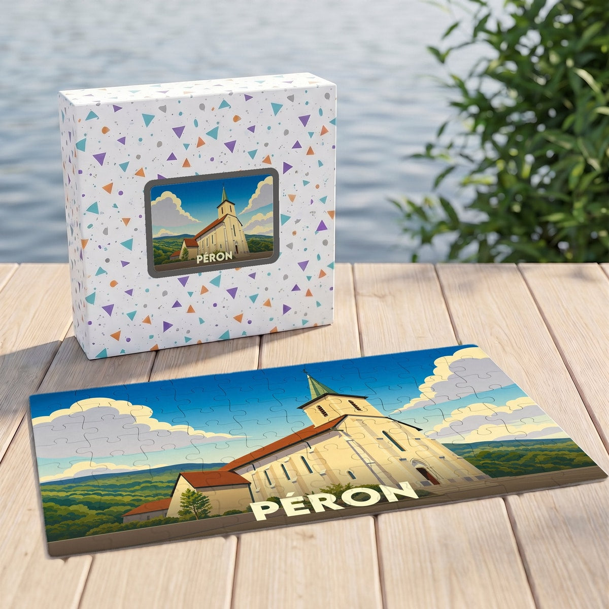 Puzzle souvenir de la ville de Péron illustré par une église stylisée, présenté avec sa boîte assortie.