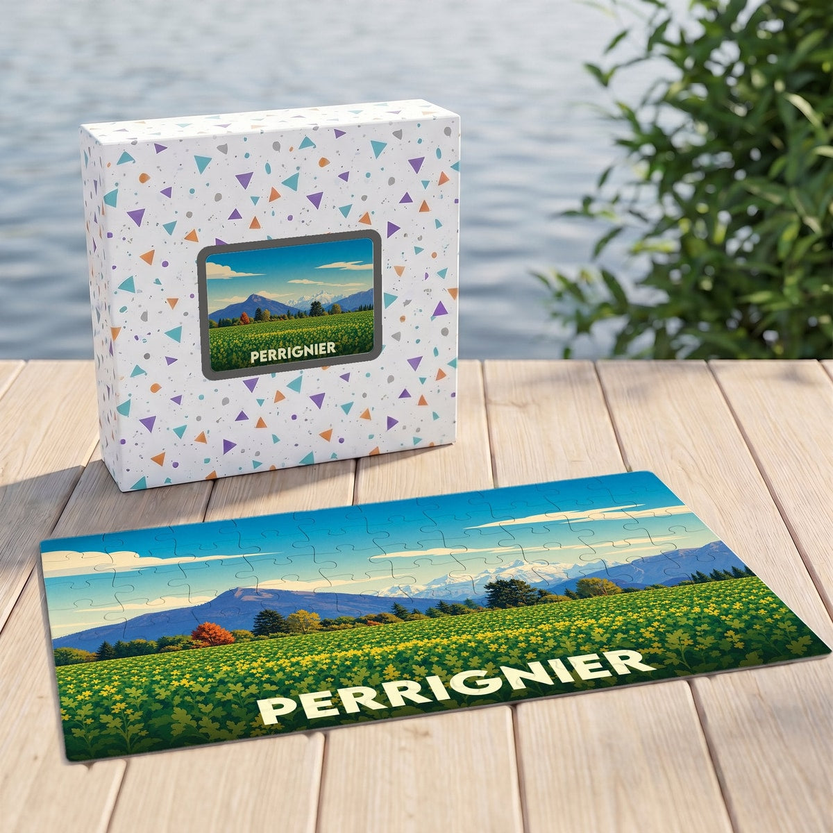 Puzzle souvenir de la ville de Perrignier illustrant un paysage de montagnes et de champs fleuris.