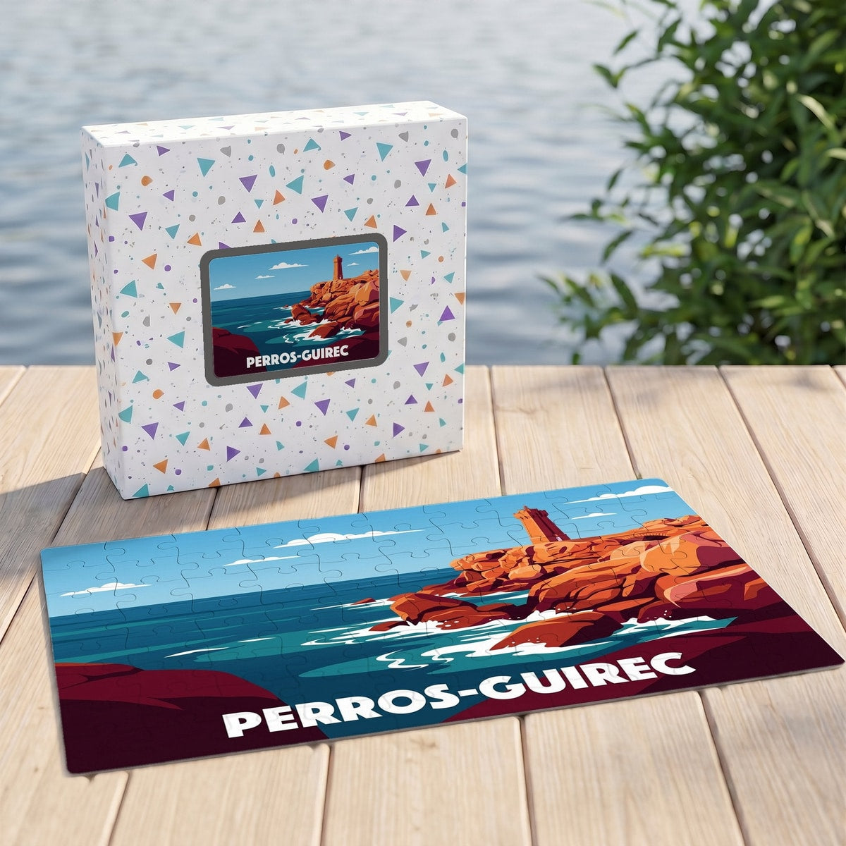 Puzzle souvenir de la ville de Perros-Guirec avec son coffret, illustrant le phare de Men Ruz de manière stylisée.