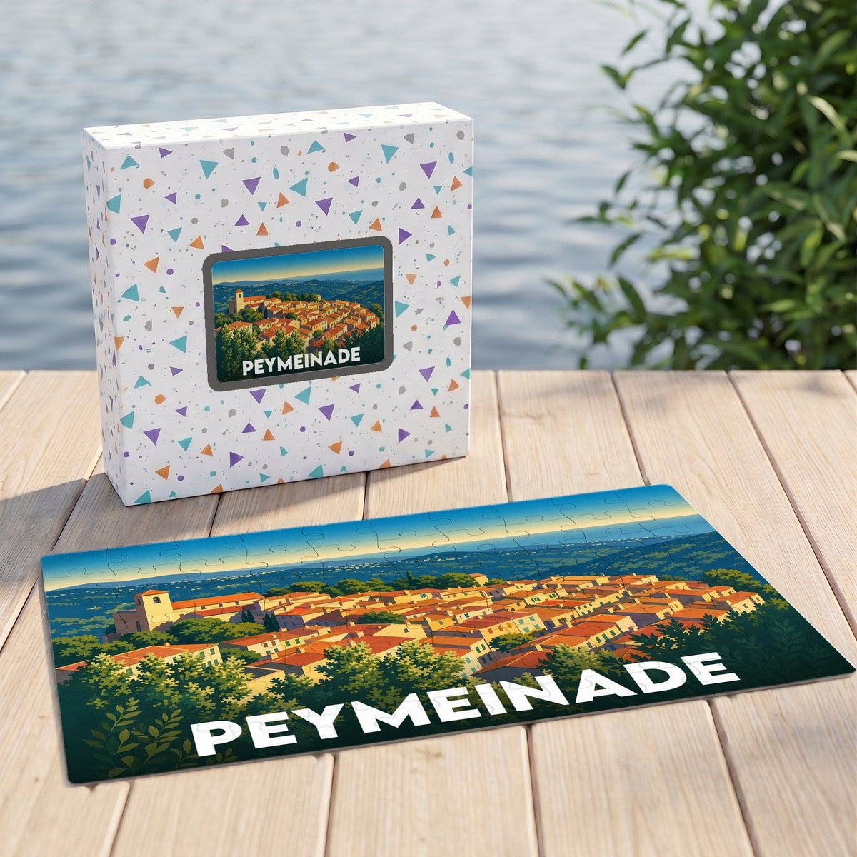 Puzzle souvenir de la ville de Peymeinade illustré d'un paysage urbain stylisé avec sa boîte assortie.