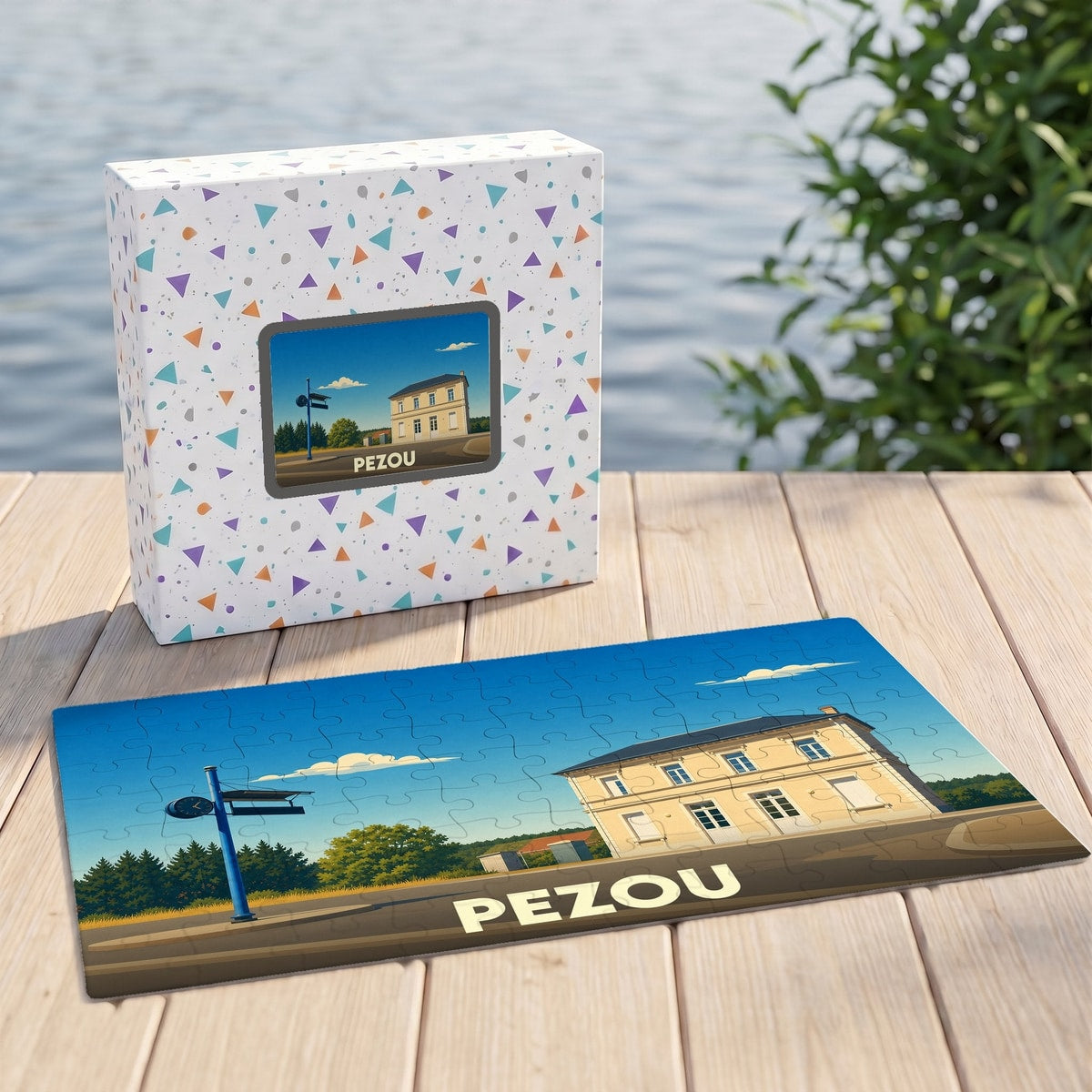 Puzzle souvenir de la ville de Pezou avec une illustration stylisée d'un bâtiment et sa boîte assortie.