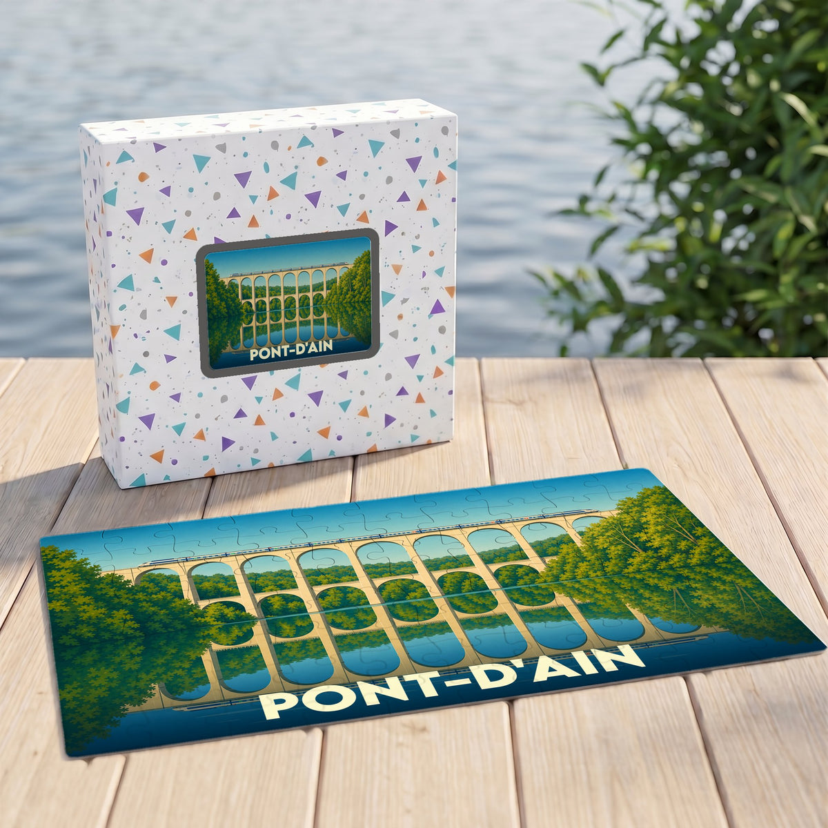 Puzzle souvenir de la ville de Pont-d'Ain avec une illustration stylisée d'un viaduc se reflétant dans l'eau.