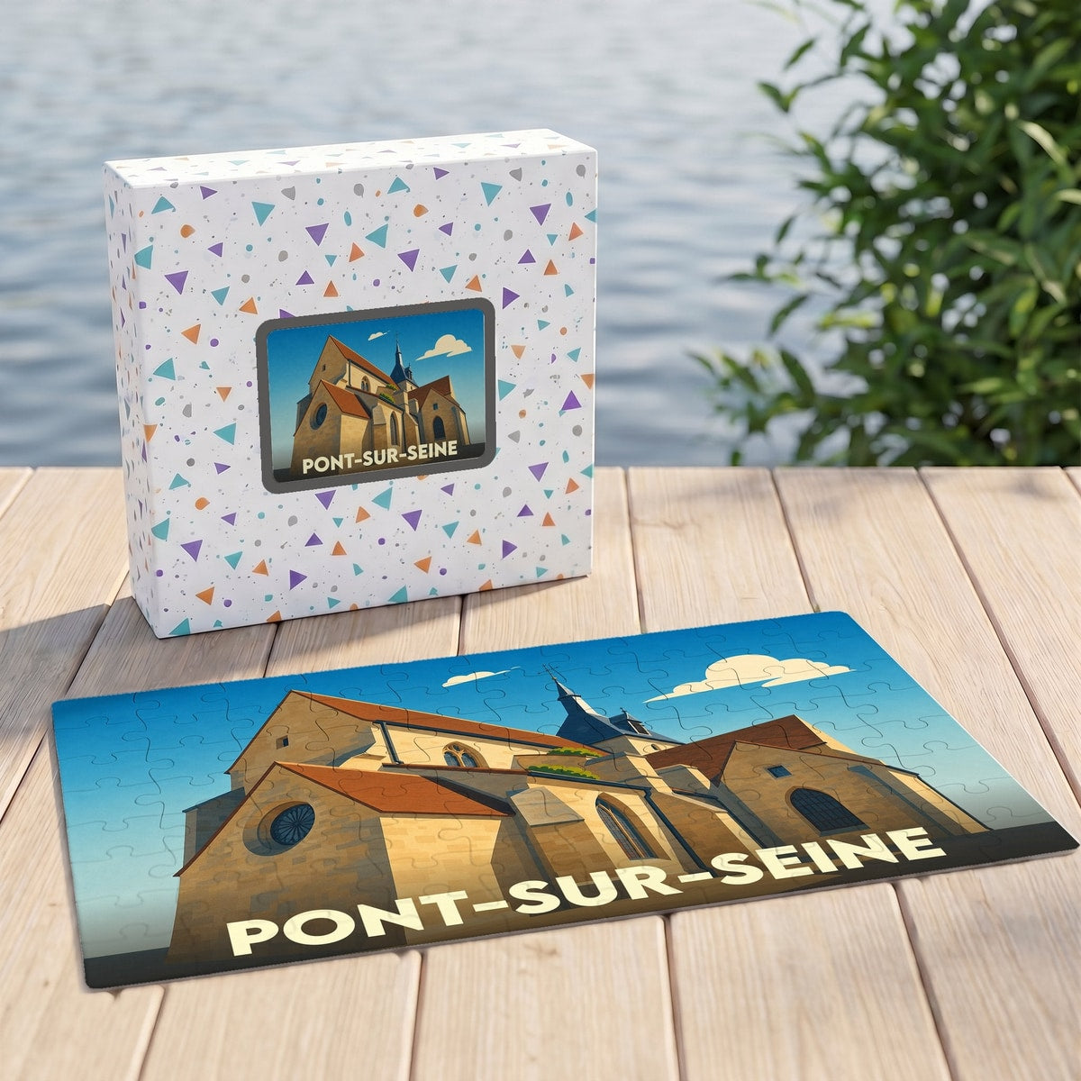Puzzle souvenir de la ville de Pont-sur-Seine avec une illustration stylisée d'une église sur sa boîte et ses pièces assemblées.