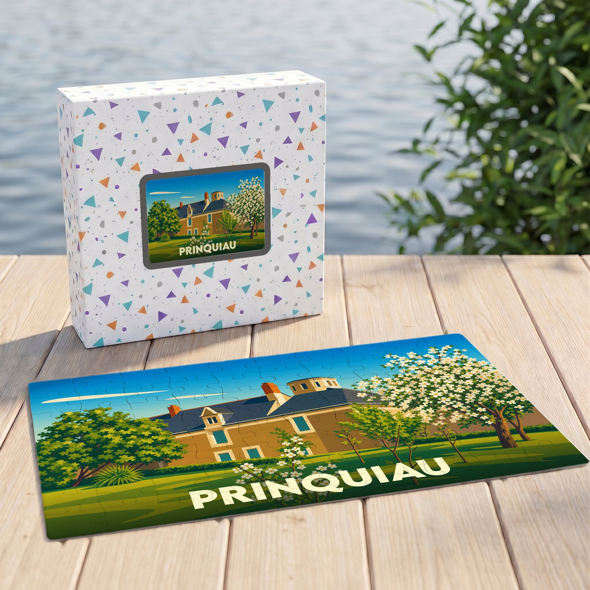 Puzzle souvenir de la ville de Prinquiau avec une illustration stylisée d'un manoir et son coffret assorti.
