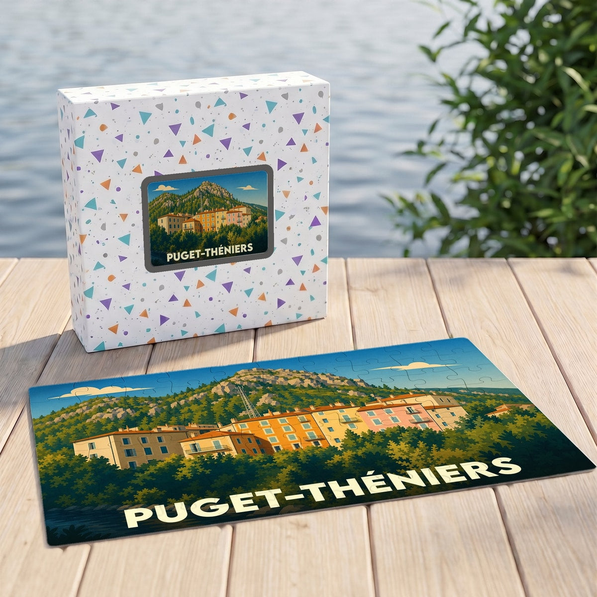 Puzzle souvenir de la ville de Puget-Théniers avec une illustration stylisée de ses façades colorées et montagnes environnantes.