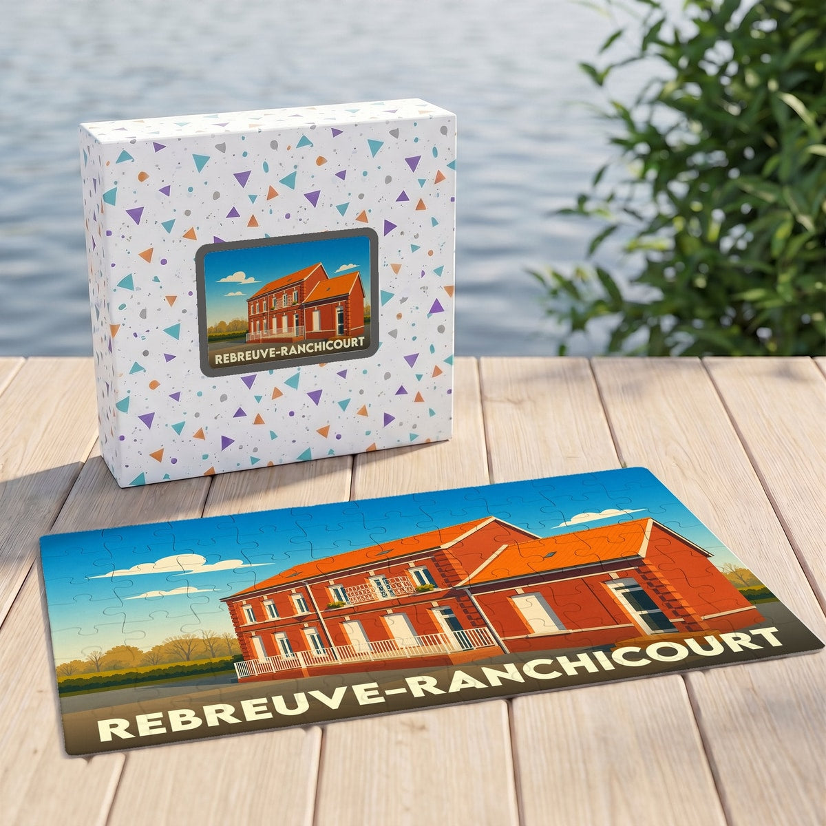 Puzzle souvenir de la ville de Rebreuve-Ranchicourt avec une illustration stylisée d'un bâtiment en briques rouges.