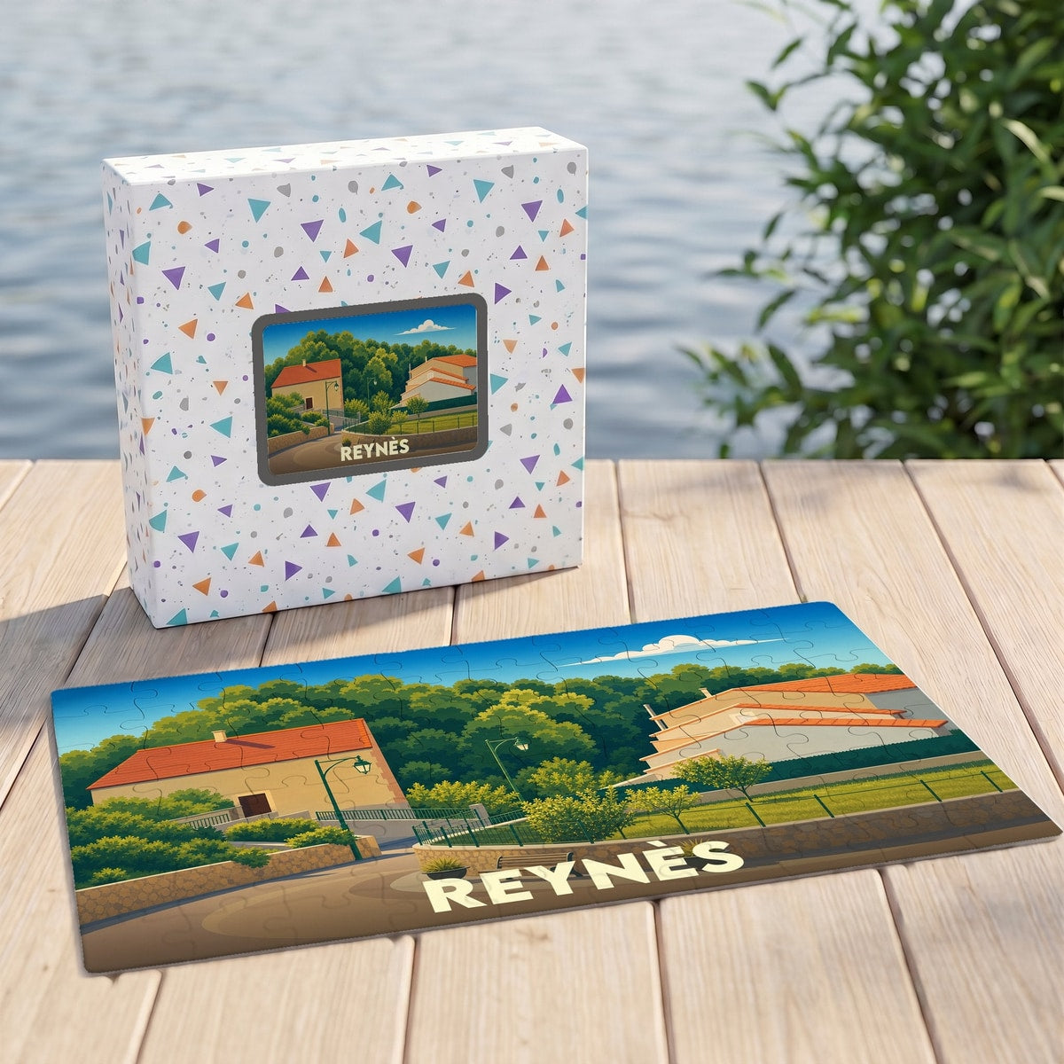 Puzzle souvenir de la ville de Reynès avec une illustration stylisée d'un paysage local.