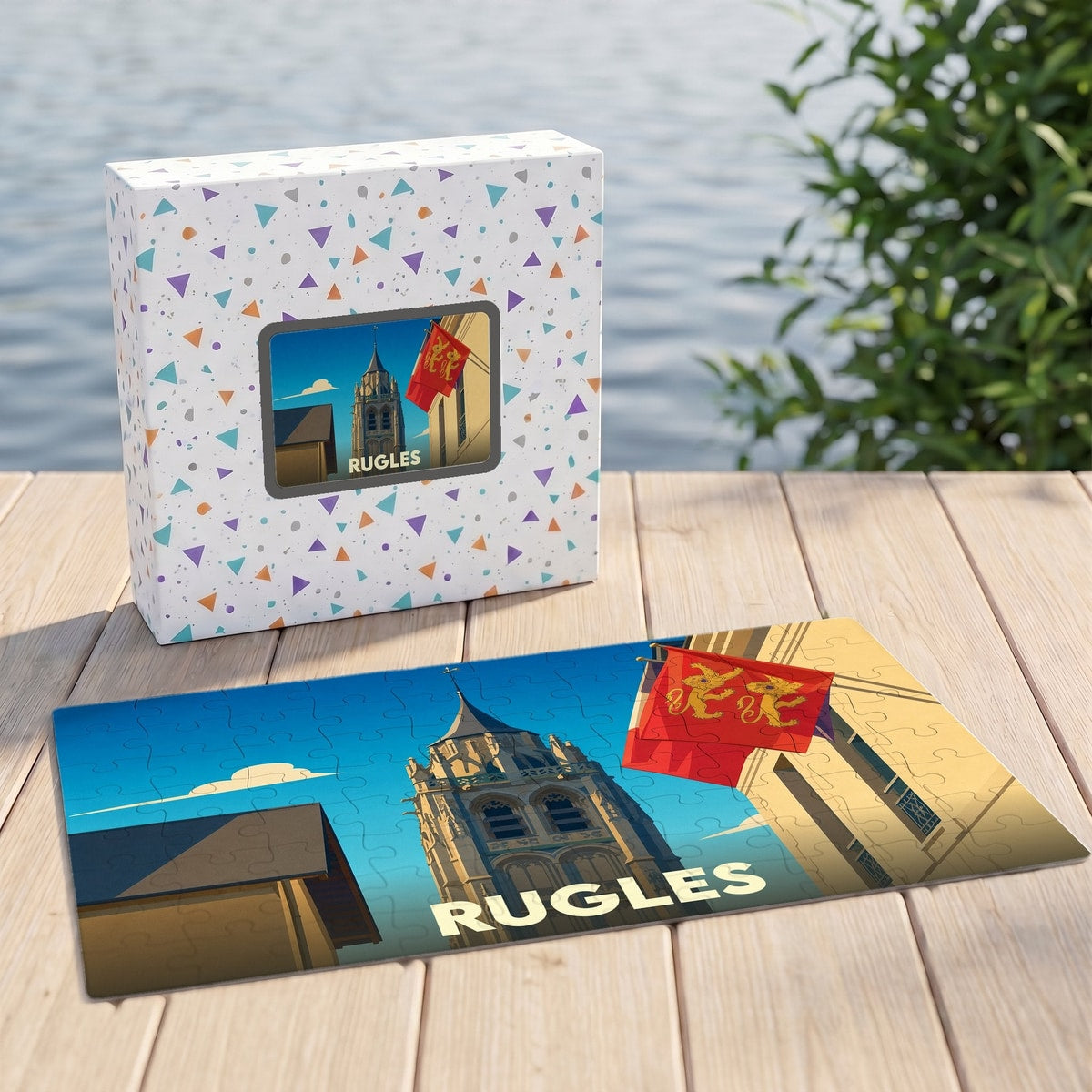 Puzzle souvenir de la ville de Rugles avec une illustration stylisée de son église et de drapeaux normands.