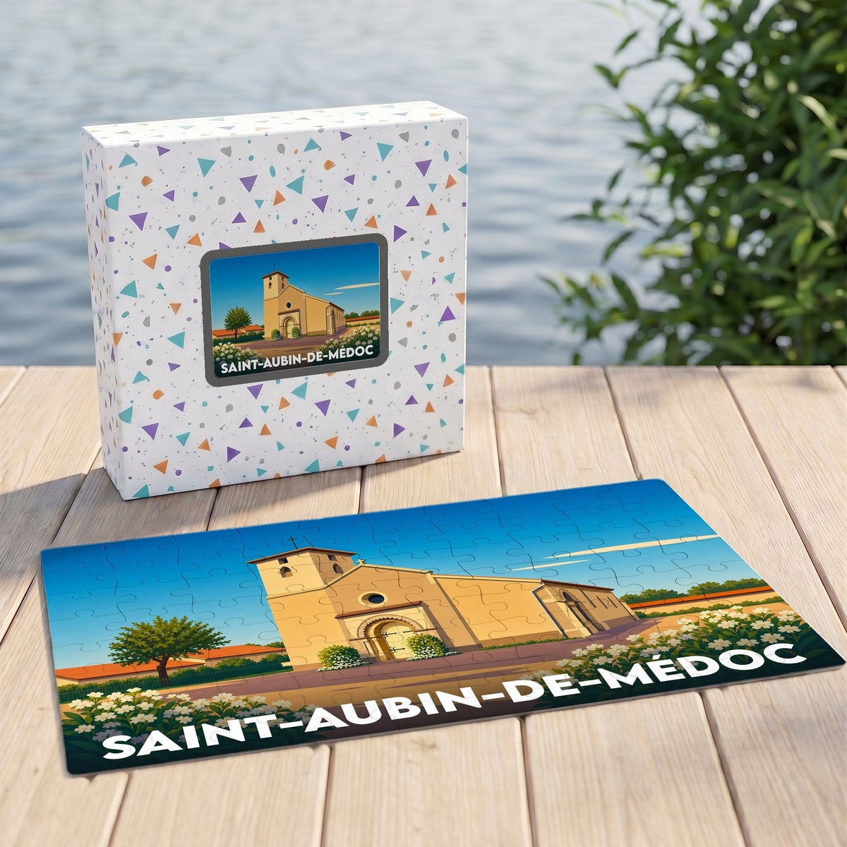Puzzle souvenir de la ville de Saint-Aubin-de-Médoc avec son coffret assorti, illustrant l'église locale dans un style épuré.