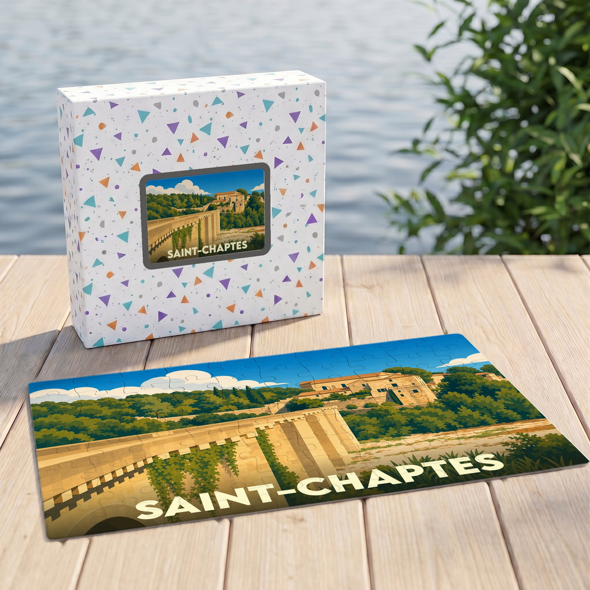 Puzzle souvenir de la ville de Saint-Chaptes avec une illustration stylisée d'un pont et de son village.