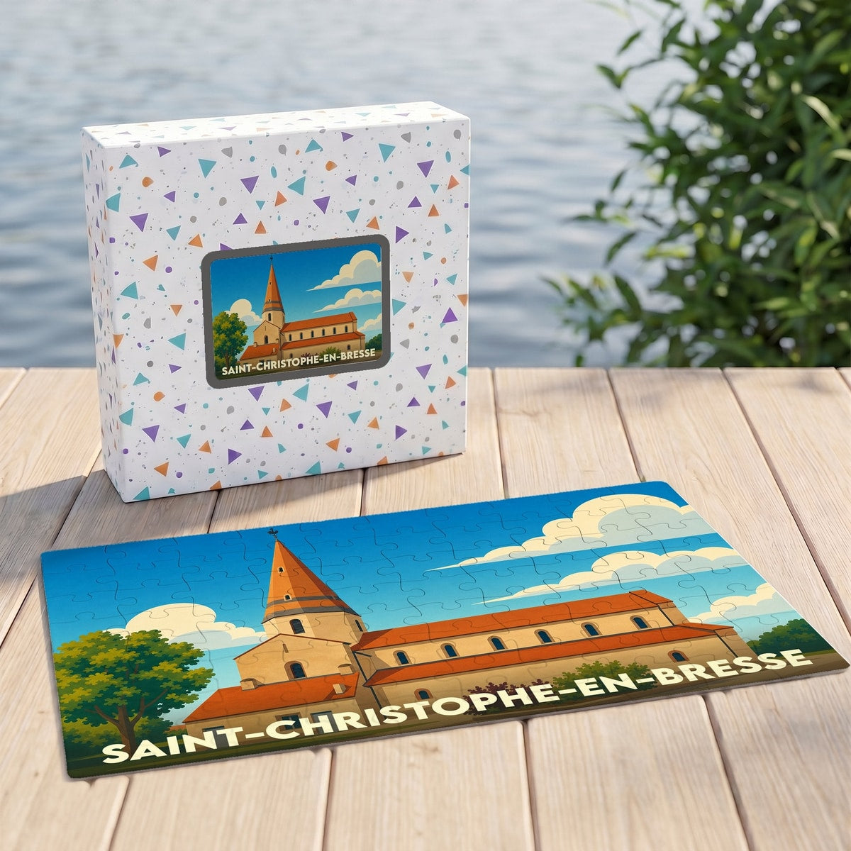 Puzzle souvenir de la ville de Saint-Christophe-en-Bresse avec son emballage et une illustration stylisée de son église.