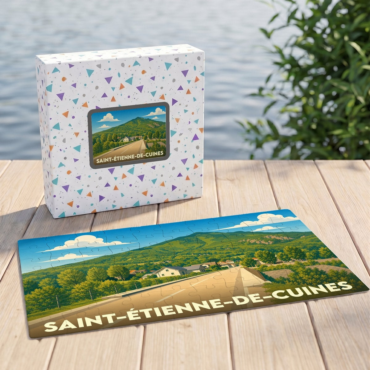 Puzzle souvenir de la ville de Saint-Étienne-de-Cuines avec une illustration paysagère stylisée.