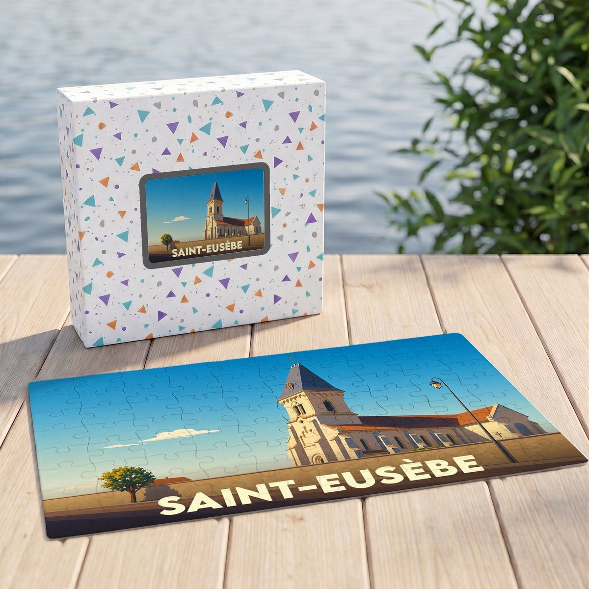Puzzle souvenir de la ville de Saint-Eusèbe avec une illustration stylisée d'une église sur sa boîte et son plateau.