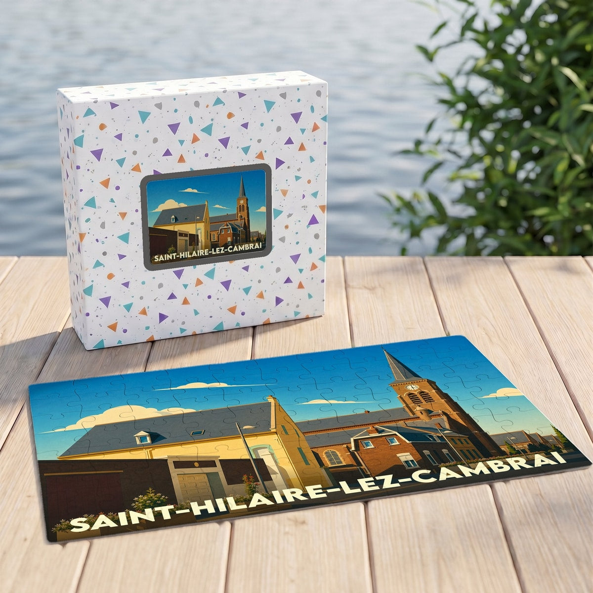Puzzle souvenir de la ville de Saint-Hilaire-lez-Cambrai avec une illustration stylisée et colorée de son église et de ses bâtiments typiques.