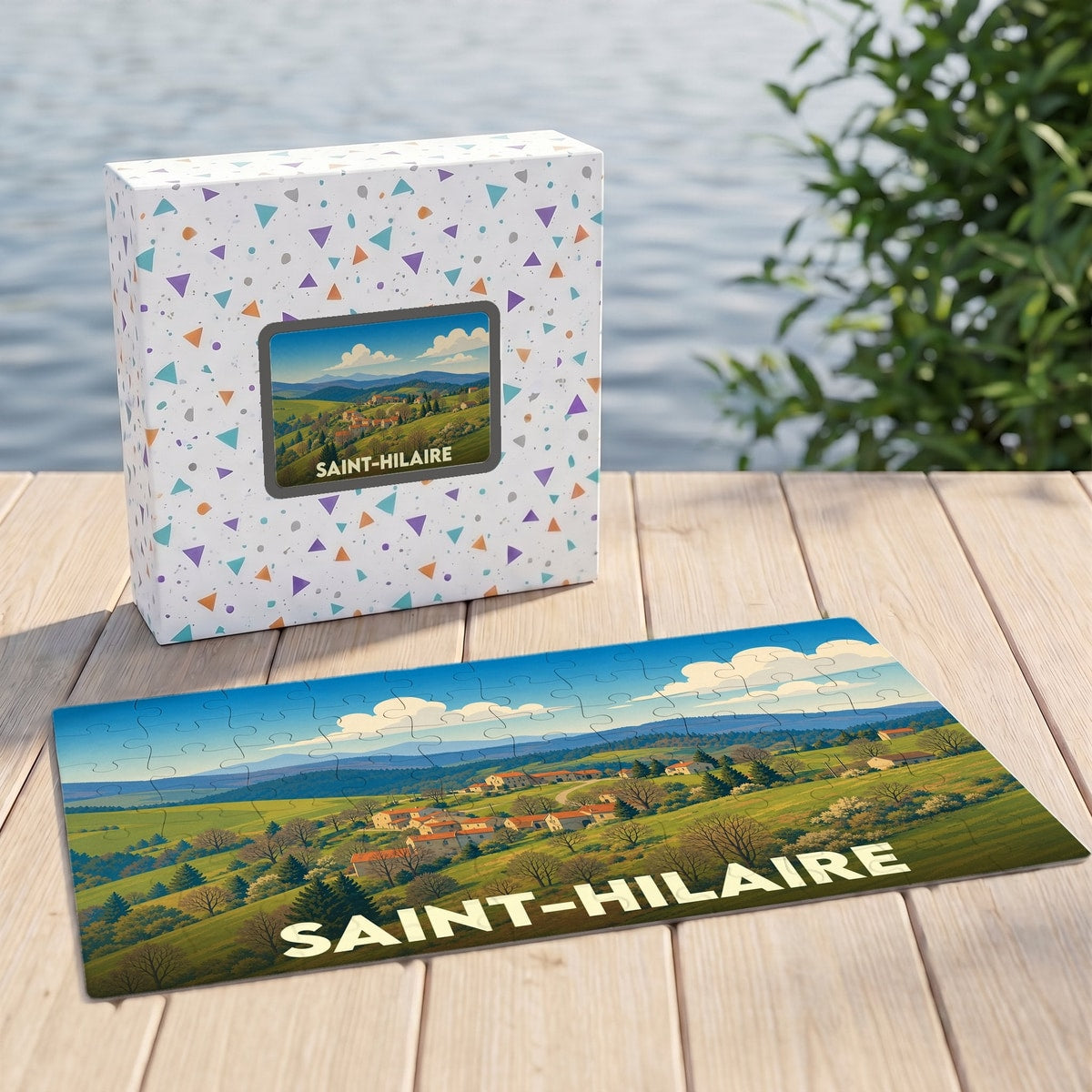 Puzzle souvenir de la ville de Saint-Hilaire illustrant un paysage de campagne vallonné.