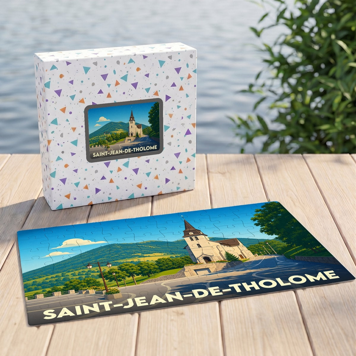 Puzzle souvenir de la commune de Saint-Jean-de-Tholome illustré par un paysage de montagne et son église.