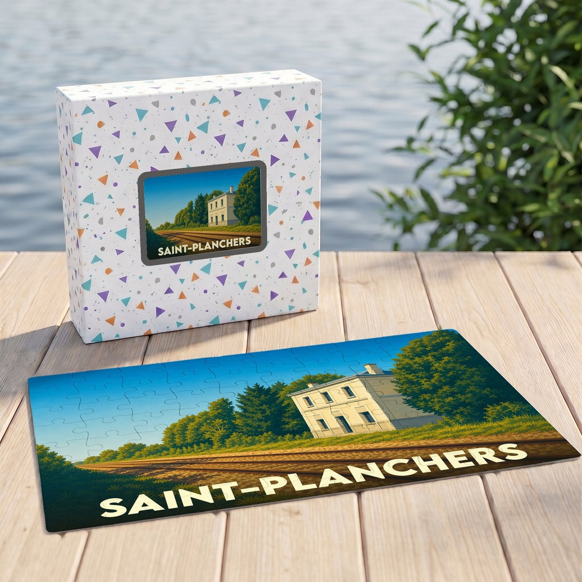 Puzzle souvenir de la ville de Saint-Planchers avec une illustration stylisée d'une maison en bordure de voie ferrée.