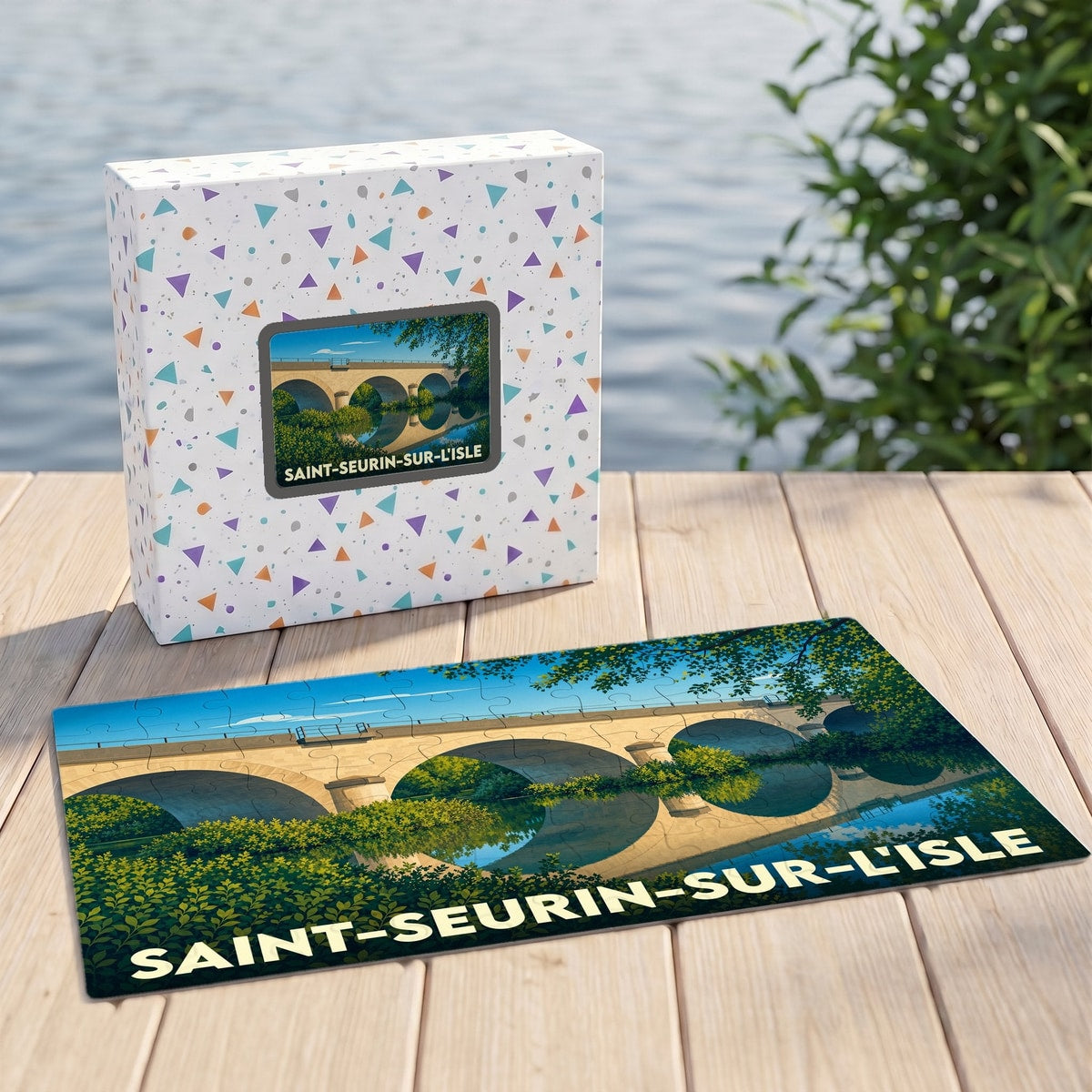Puzzle souvenir de la ville de Saint-Seurin-sur-l'Isle avec une illustration stylisée d'un pont en pierre.