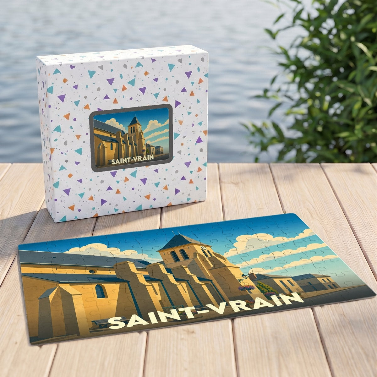 Puzzle souvenir de la ville de Saint-Vrain avec son coffret assorti illustrant une église stylisée.