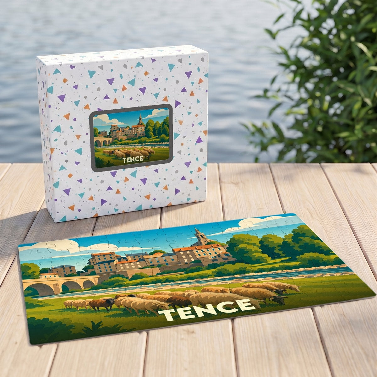 Puzzle souvenir de la ville de Tence illustrant un paysage champêtre stylisé avec son église et un troupeau de moutons.