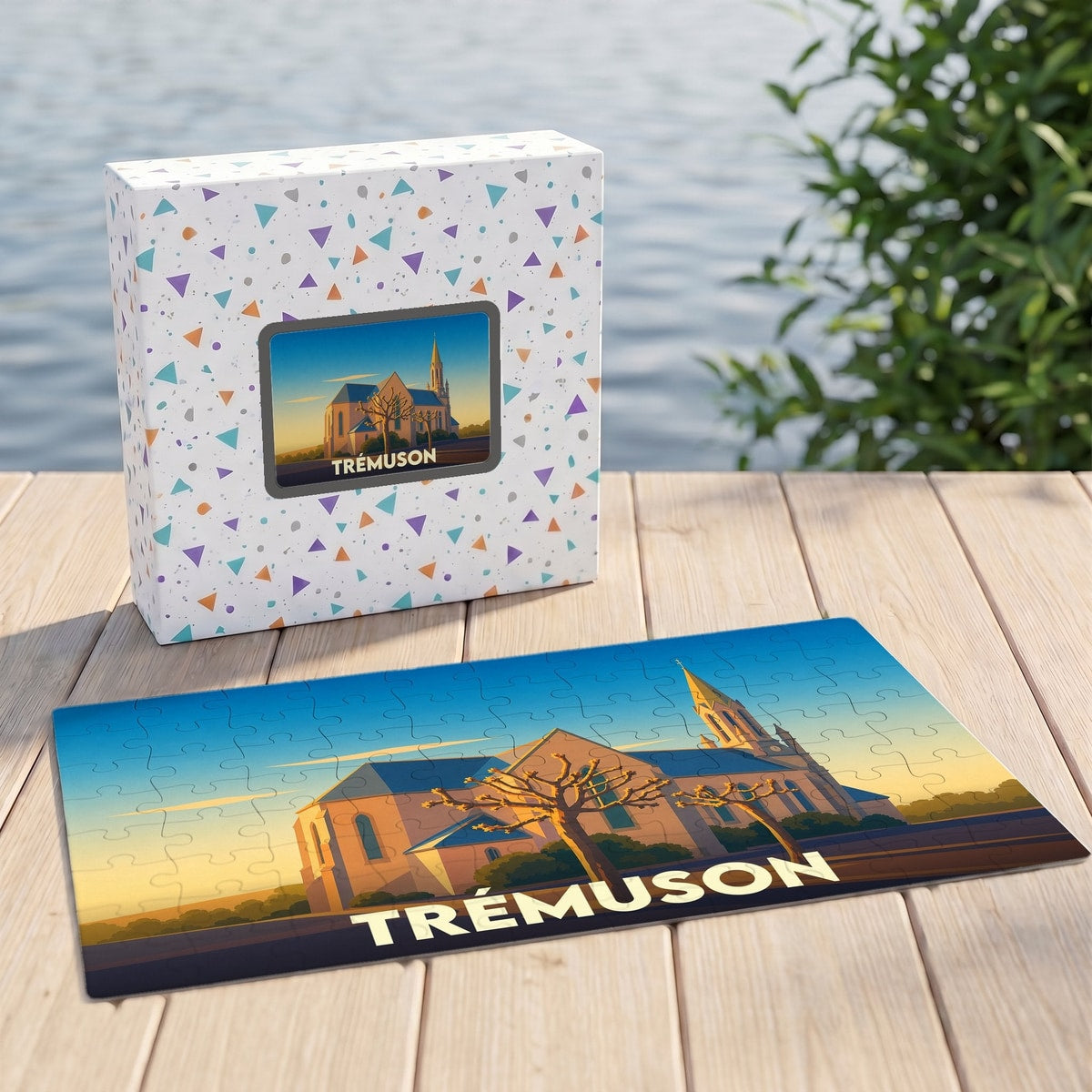 Puzzle souvenir de la ville de Trémuson avec une illustration stylisée d'une église au coucher du soleil.