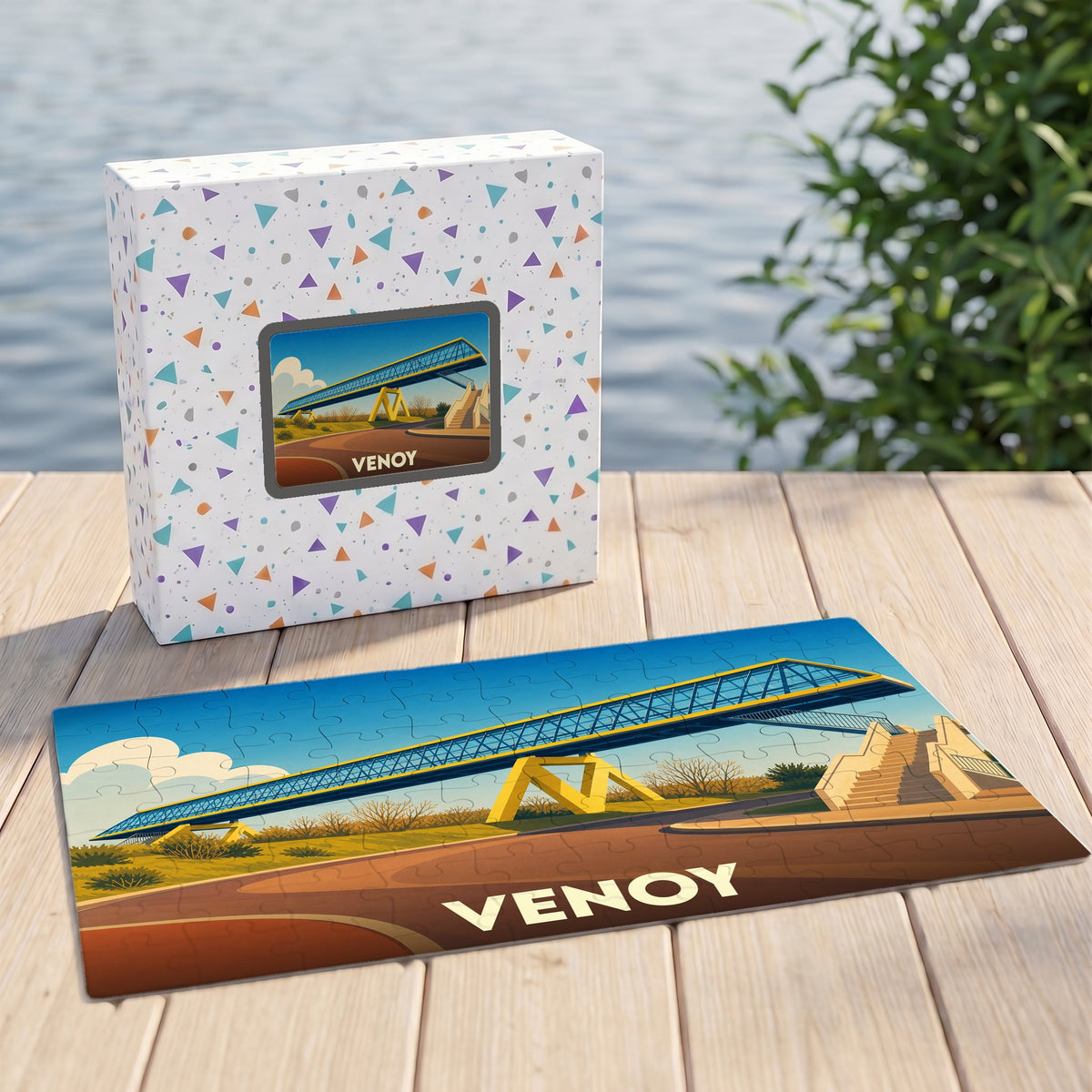 Puzzle souvenir de la ville de Venoy illustrant une passerelle moderne sur un fond paysager coloré.