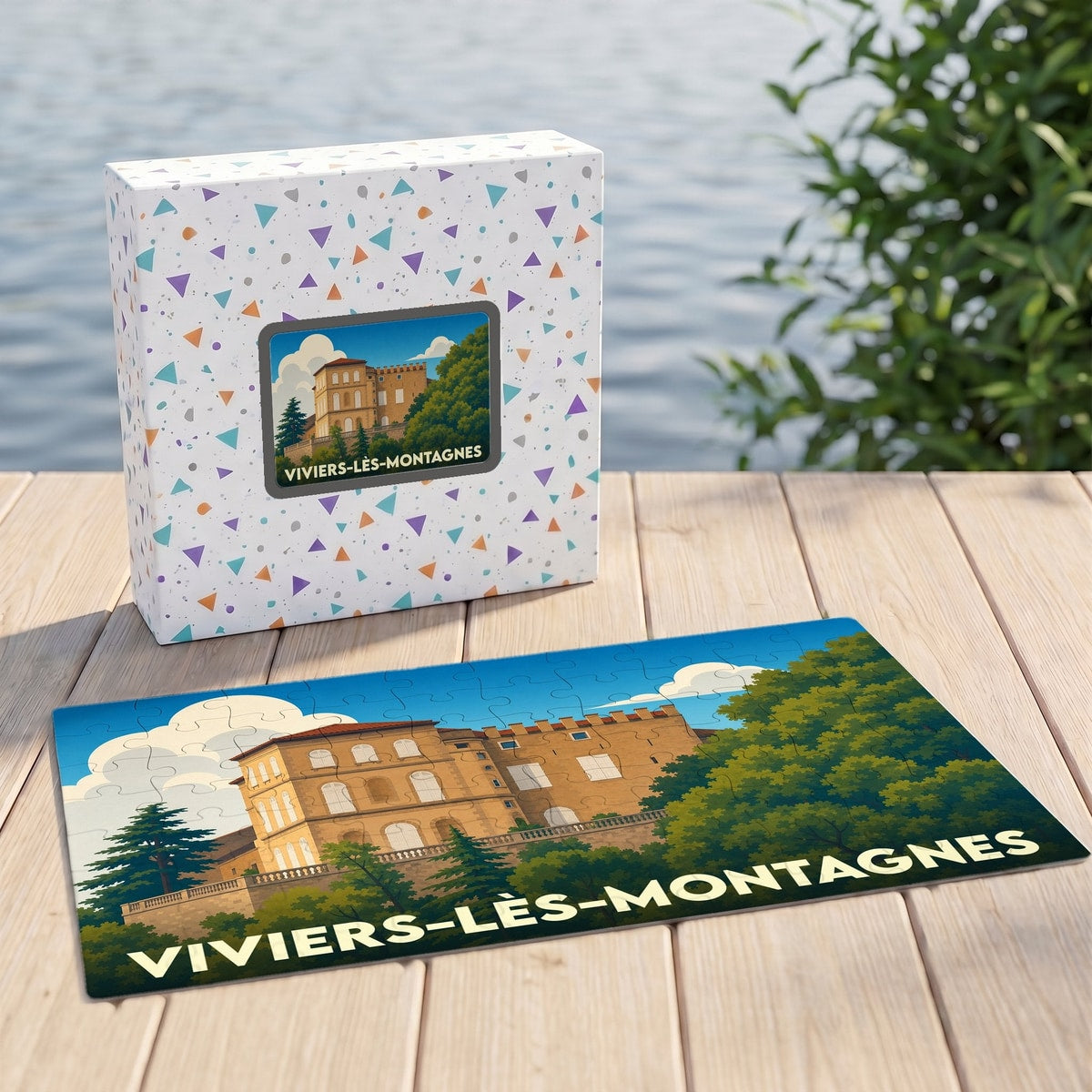 Puzzle souvenir de la ville de Viviers-lès-Montagnes avec son boîte de rangement et une illustration stylisée du château.