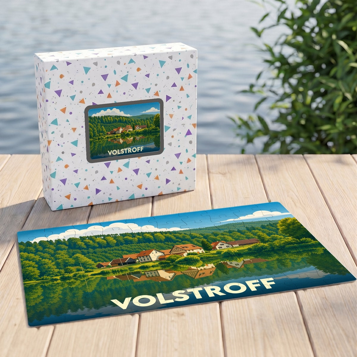 Puzzle souvenir de la ville de Volstroff représentant un paysage de campagne au bord de l'eau.