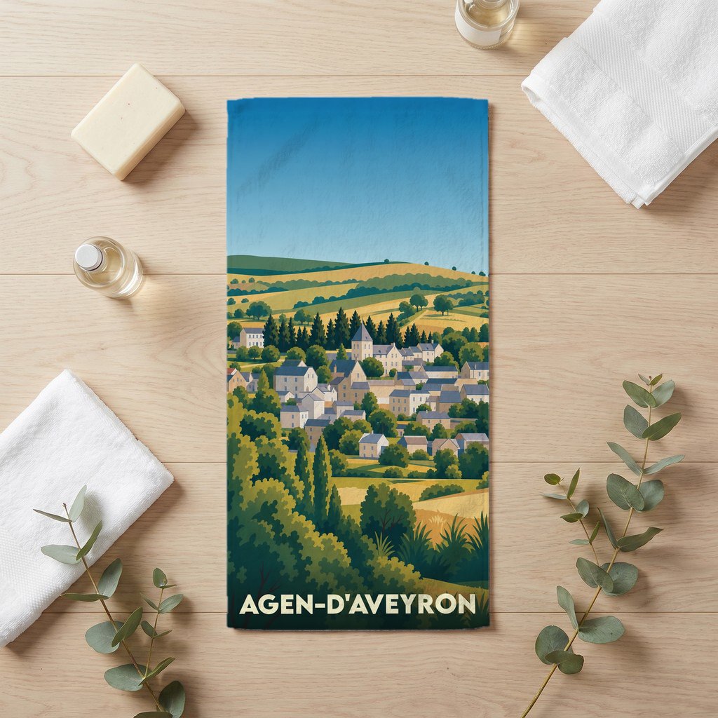 Serviette de bain souvenir de la ville d'Agen-d'Aveyron avec une illustration stylisée de son paysage vallonné.