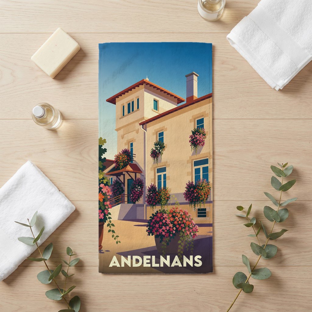 Serviette de bain souvenir de la ville de Andelnans avec une illustration stylisée d'un bâtiment fleuri.