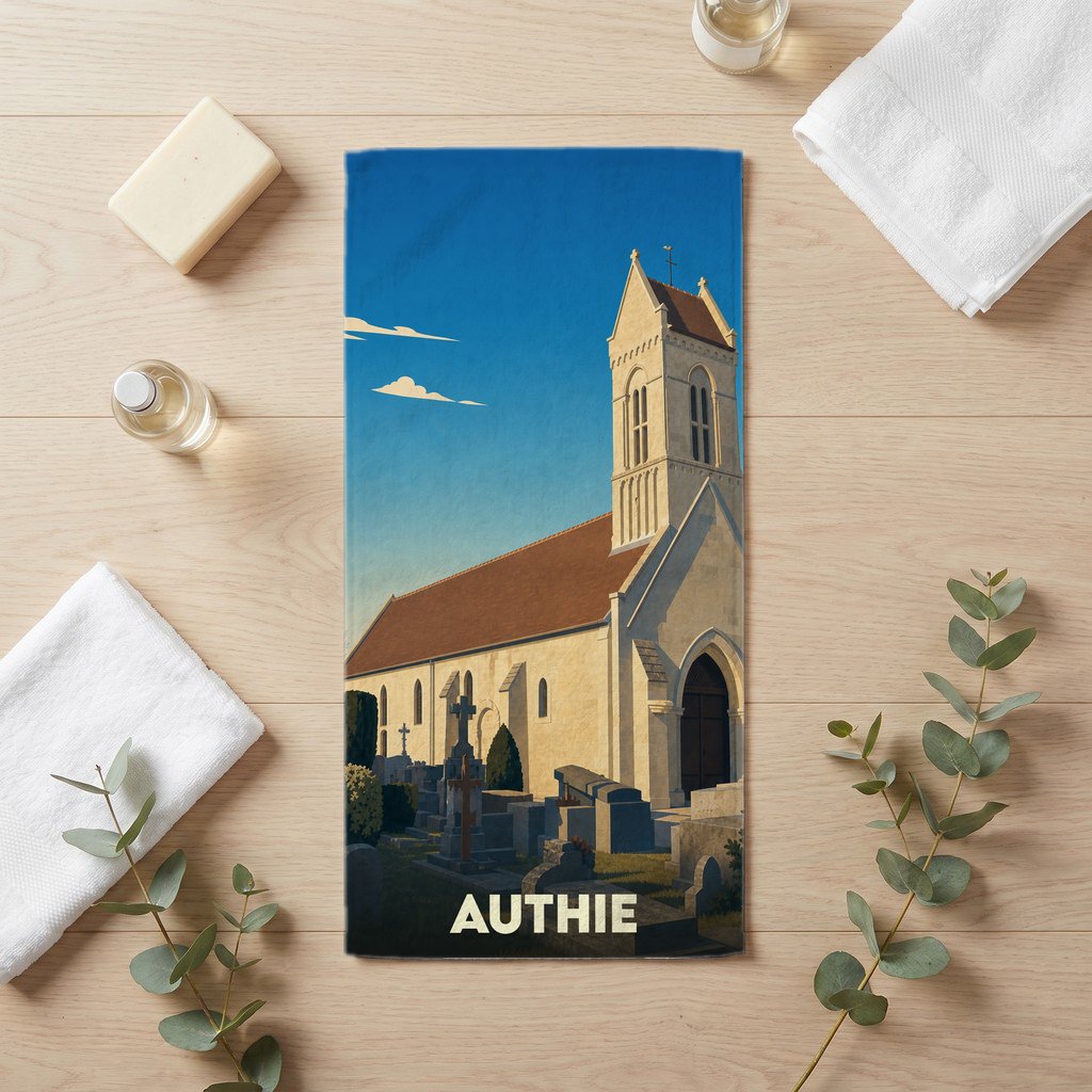 Serviette de bain souvenir de la ville d'Authie avec une illustration stylisée de son église et de son cimetière.