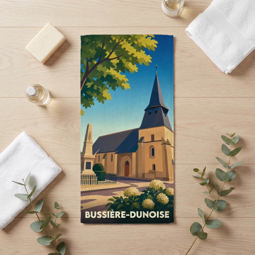 Serviette de bain souvenir de la ville de Bussière-Dunoise avec une illustration stylisée de son église.