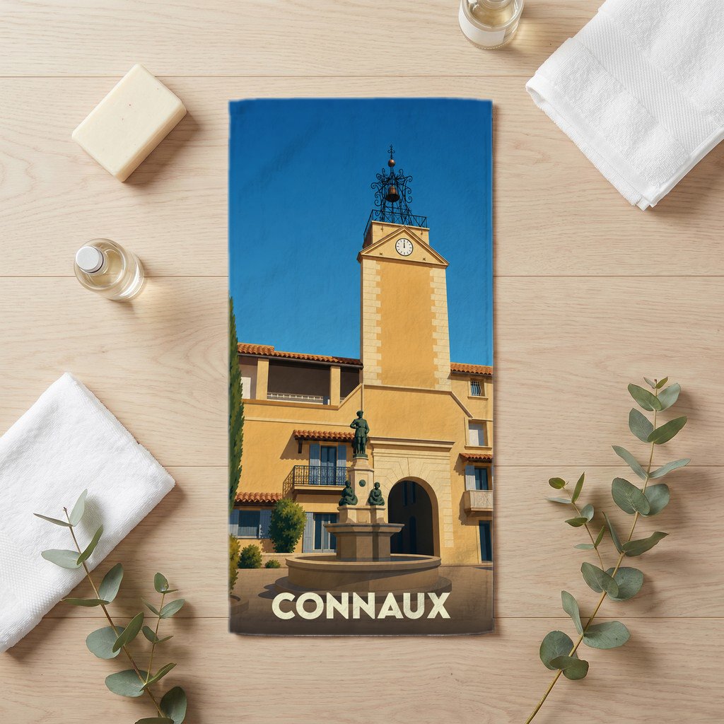 Serviette de bain souvenir de la ville de Connaux illustrée par son clocher et sa fontaine.