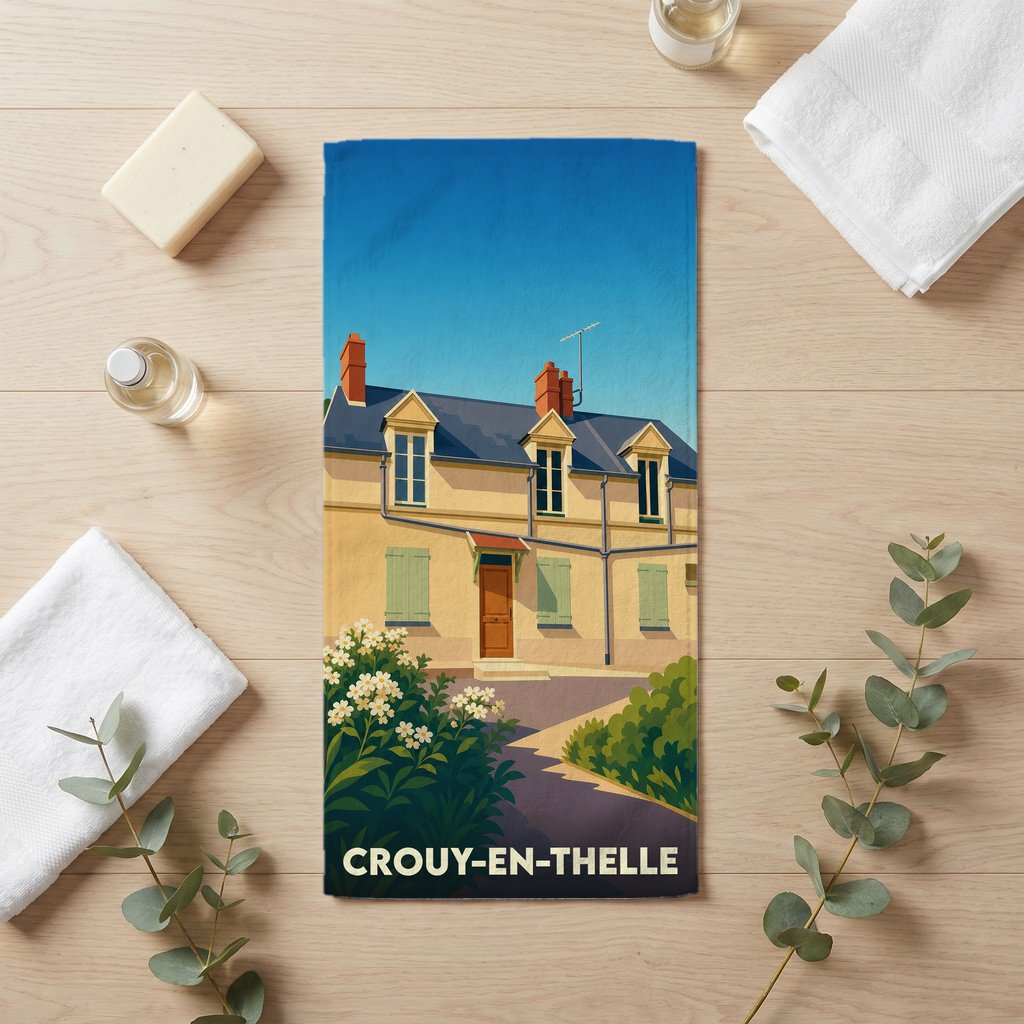 Serviette de bain souvenir de Crouy-en-Thelle avec une illustration stylisée d'une maison de ville typique.
