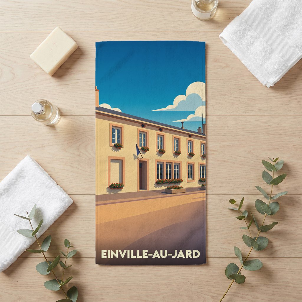 Serviette de bain souvenir de la ville d'Einville-au-Jard avec une illustration stylisée d'un bâtiment fleuri.