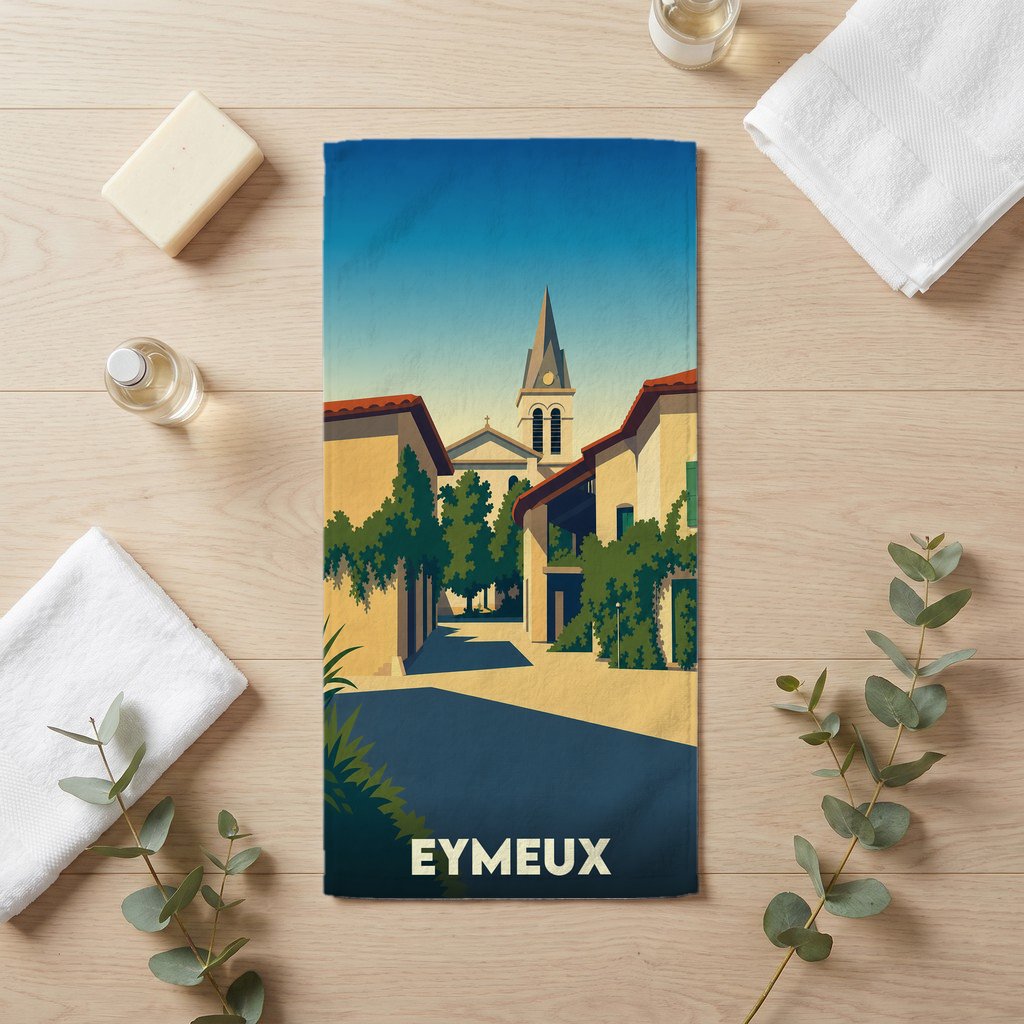 Serviette de bain souvenir de la ville d'Eymeux avec une illustration stylisée d'une rue ensoleillée menant à l'église.