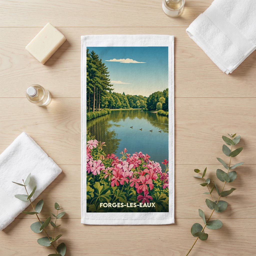 Serviette de bain souvenir de Forges-les-Eaux illustrée d'un paysage de lac bordé de fleurs roses.