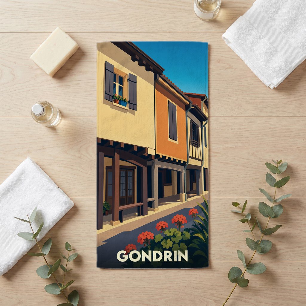 Serviette de bain souvenir de la ville de Gondrin avec une illustration stylisée de maisons colorées.
