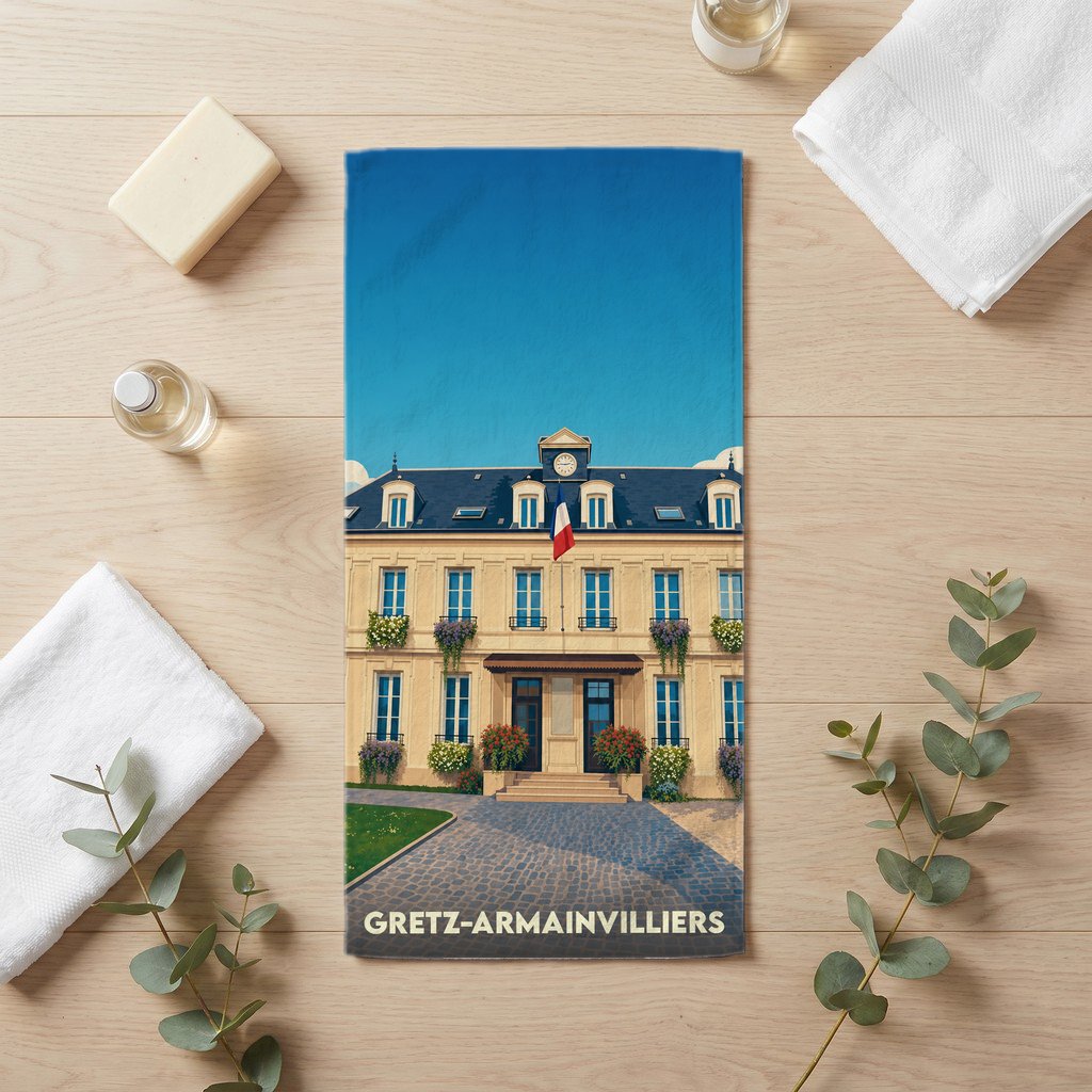 Serviette de bain souvenir de la ville de Gretz-Armainvilliers avec une illustration stylisée de sa mairie.